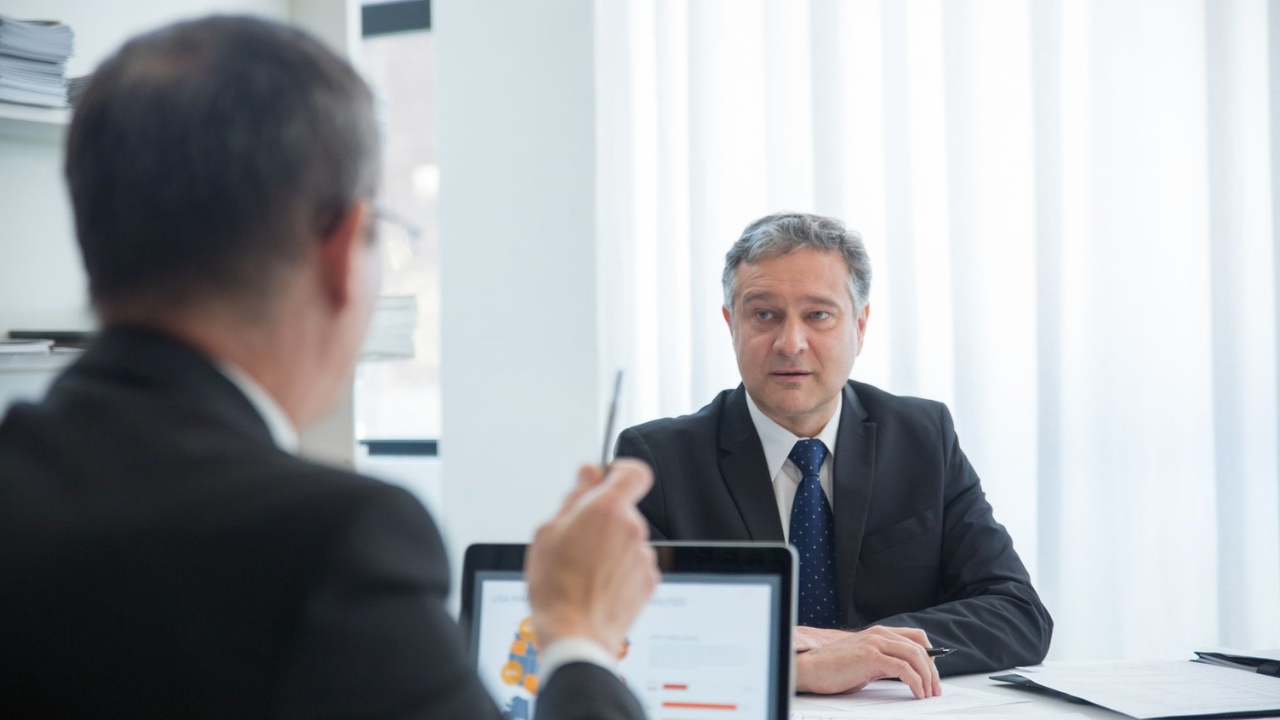 Business leaders reviewing questions before approving a Wi-Fi survey scope.