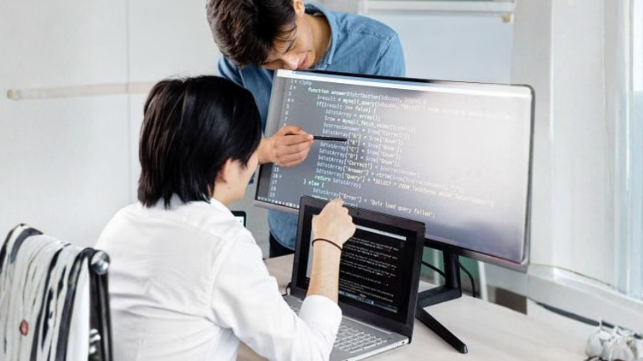 IT professionals reviewing cybersecurity systems and service requirements for a small business.