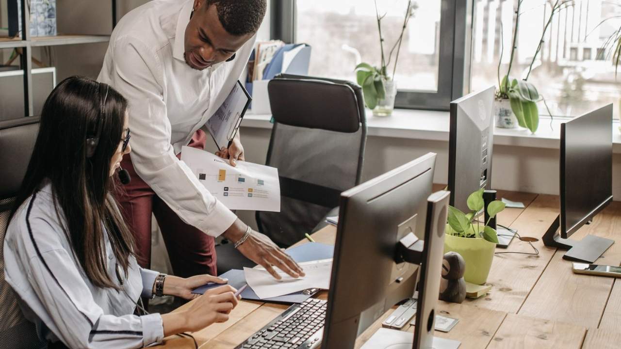 Business team comparing in-house and outsourced IT support options.