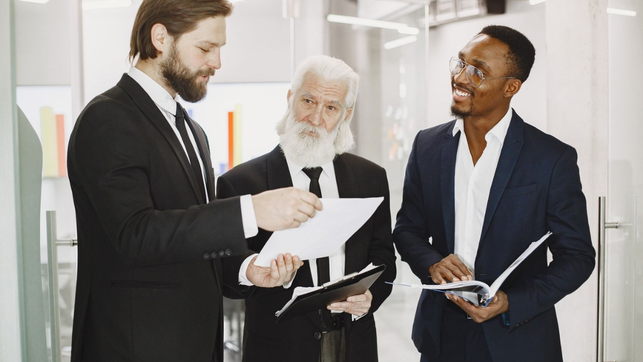 Business leaders reviewing costs for in-house and outsourced IT support services.