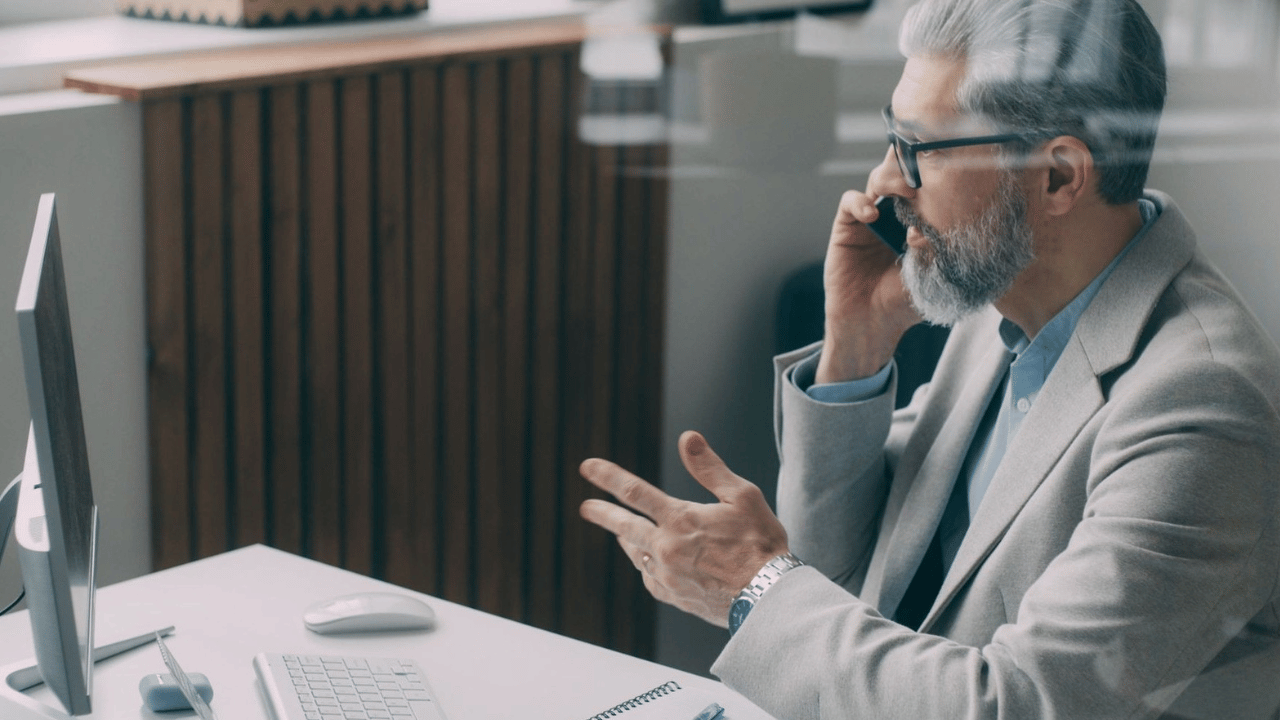 Business professional discussing fixed-fee managed IT pricing and monthly support costs.