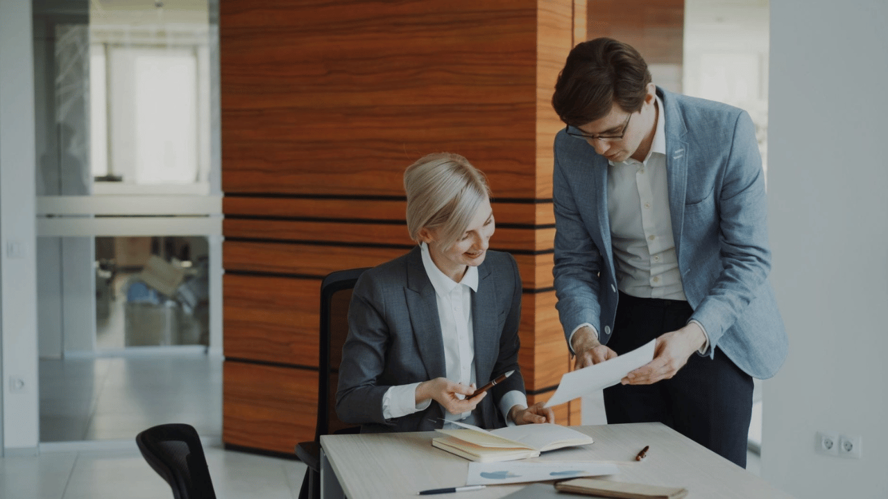 Business professionals reviewing per-user managed IT pricing and employee support costs.