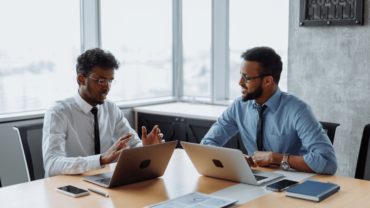 Business professionals comparing managed IT pricing options before choosing a service model.