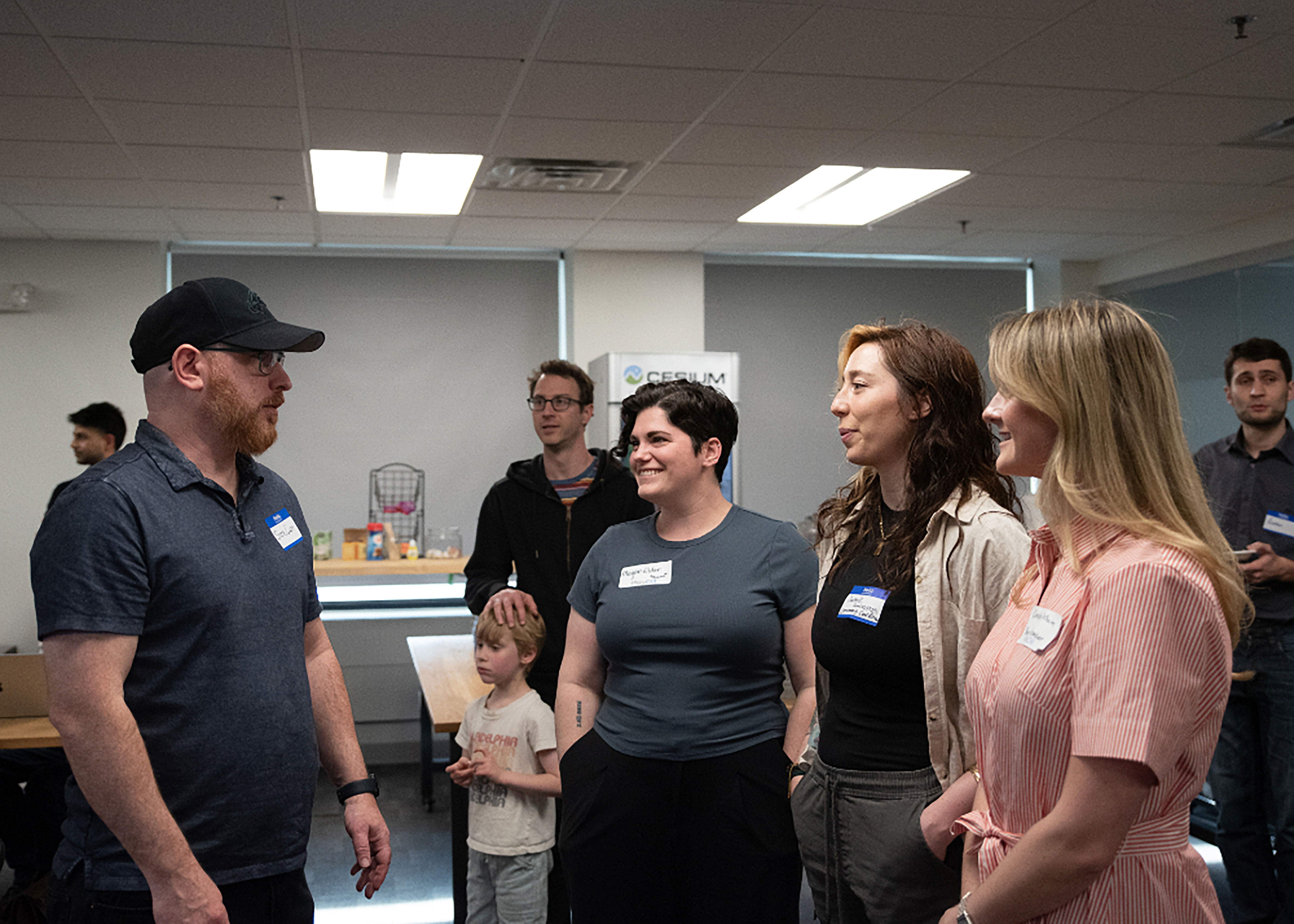 a PhillyCHI member speaking to Megan, Jamie, and Lindsay at an in-person job event organized by Jamie and PhillyCHI