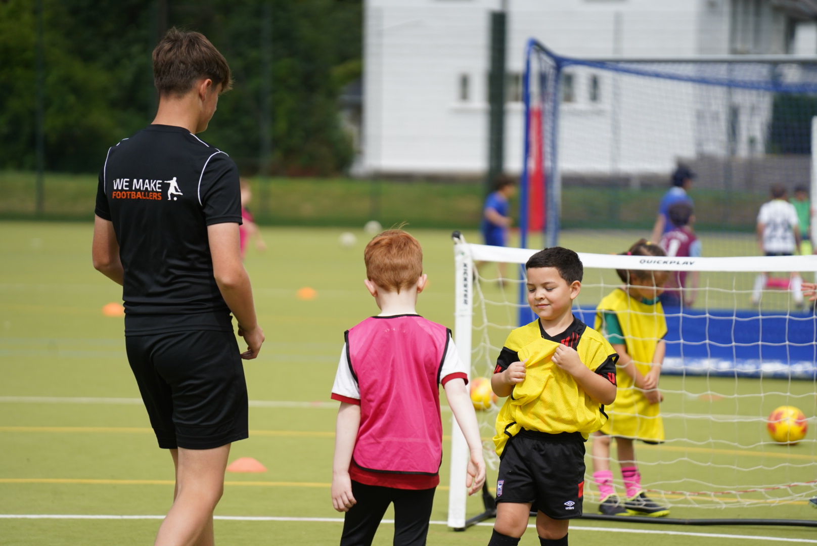 Children playing soccer outdoors, improving coordination and reacting to movement drills.