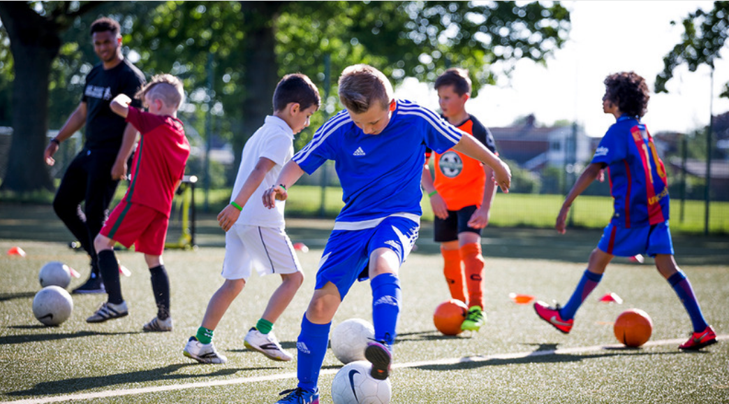 Young soccer players enjoying outdoor training under sunny Australian skies.