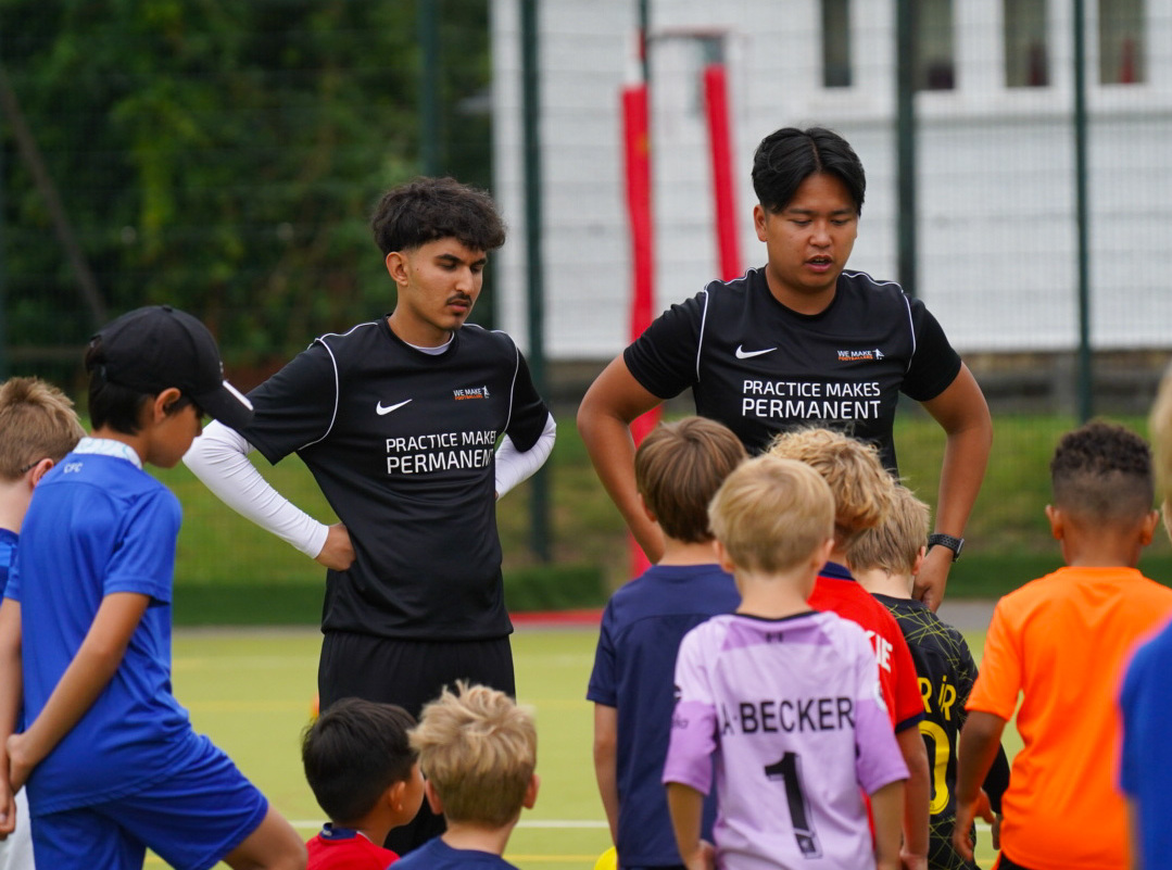 Kids learning football skills together in a positive and inclusive Aussie environment.