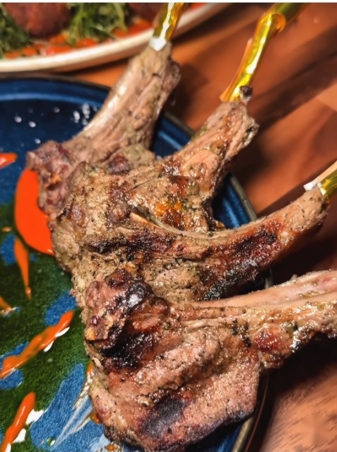 Grilled New Zealand lamb chops with signature Haitian herb marinade at Duke's Steakhouse