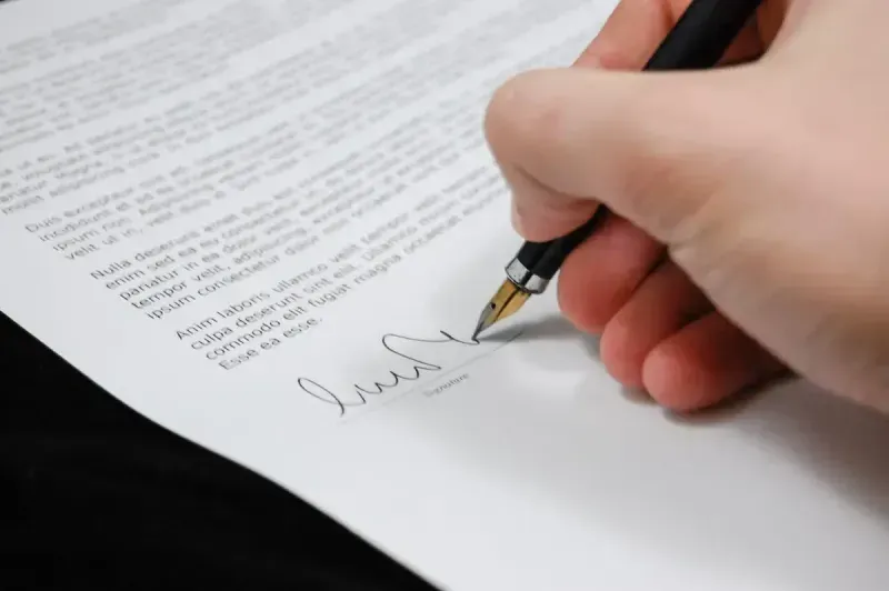 A man signs a legal document