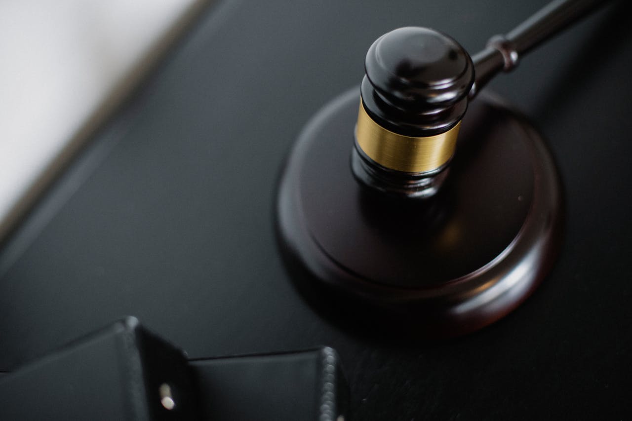 A balance scale and gavel on a desk, symbolizing justice and law.