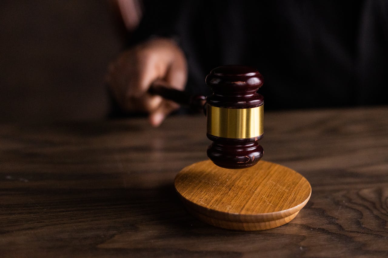 A judge's gavel rests on a polished wooden table, symbolizing authority and the judicial process.