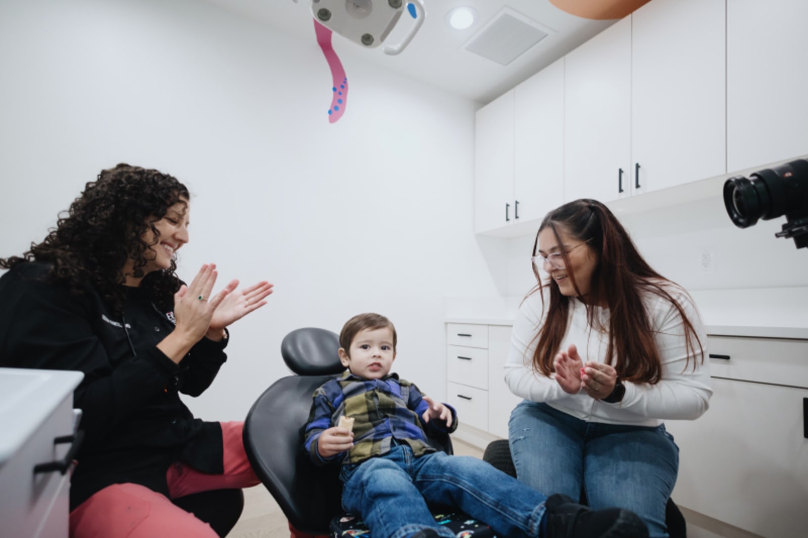 Pediatric dentist working with child patient during dental procedure