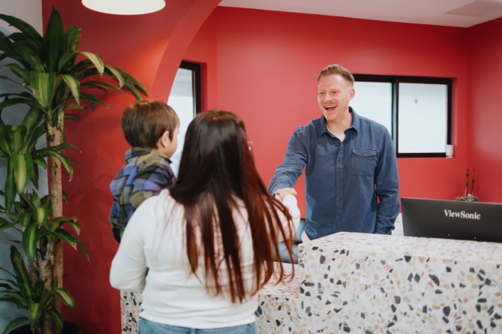 Parent and child checking in at the front desk of El Segundo Pediatric Dentistry