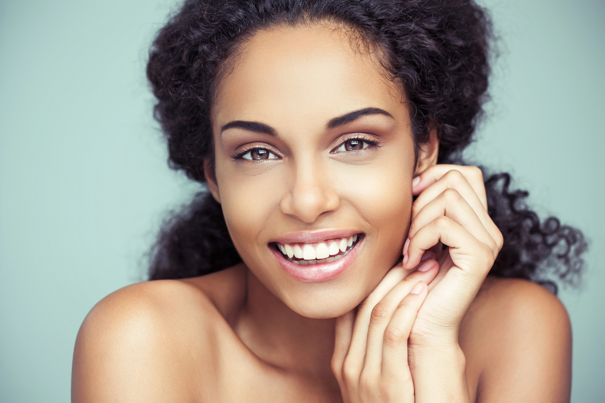 Smiling woman with smooth, even-looking skin, representing the skin rejuvenation benefits of a Tetra CoolPeel treatment.
