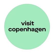 Circle with mint green background and black text reading 'visit copenhagen'.