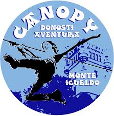 Logo with silhouette of person ziplining against a blue mountainous background, labeled Canopy Donosti Aventura Monte Igueldo.