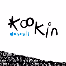 Logo with the word 'Kookin' in black stylized text and 'donosti' in blue lowercase letters below, above a black band with white food icons.