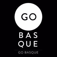 Go Basque logo with 'GO' inside a white circle above the text 'BASQUE' and 'GO BASQUE' below on a black background.