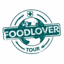 Green circular logo with a globe in the background and the word FOODLOVER stamped across it, with 'TOUR' below.