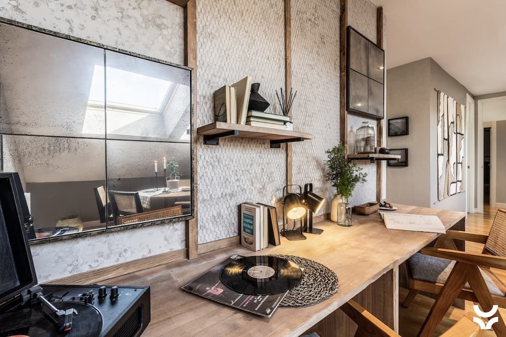 Desk area with mirror and textured tiles on wall