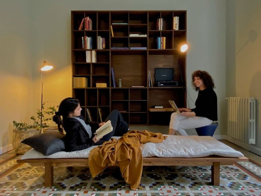 two people talking while lounging in living room