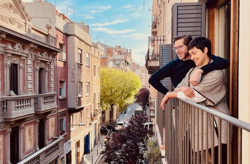 couple looking out from balcony