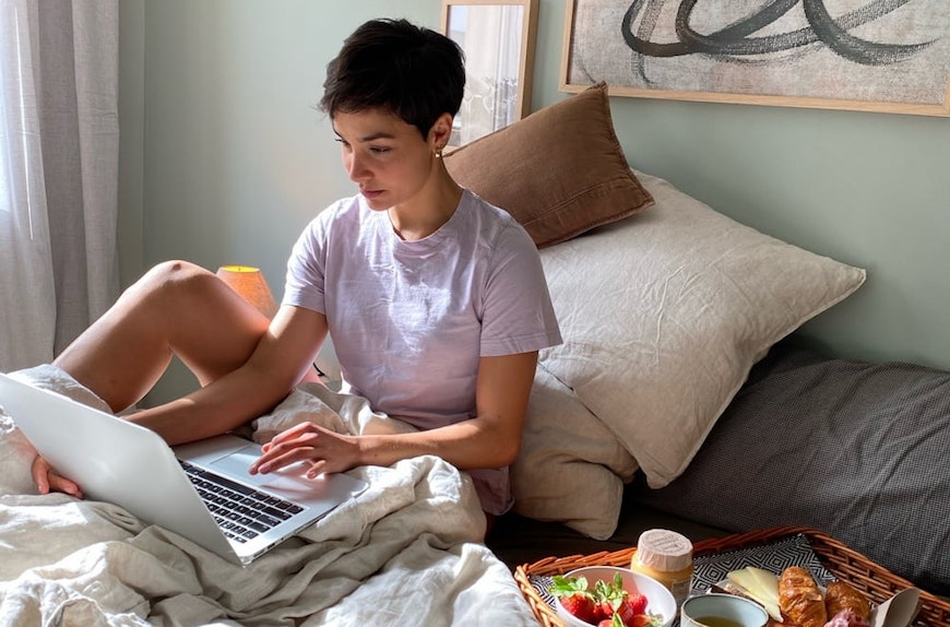 woman in bed on computer