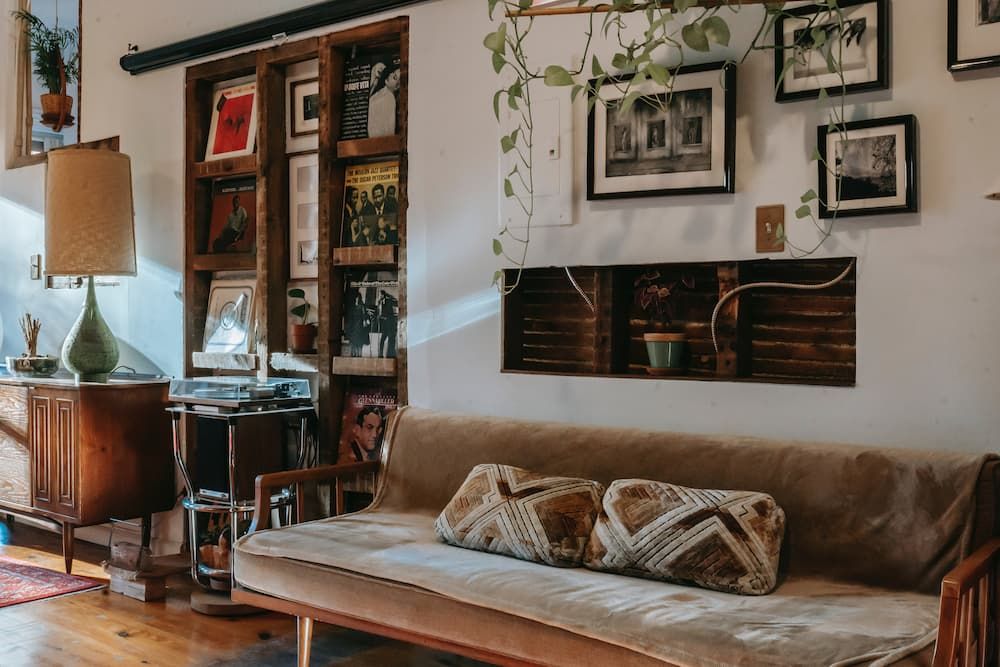 Plants hanging on a shelf in a nicely decorated living room
