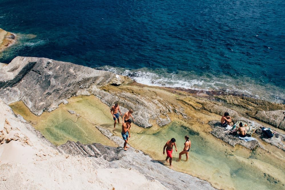 People on a sunny beach on the rocks