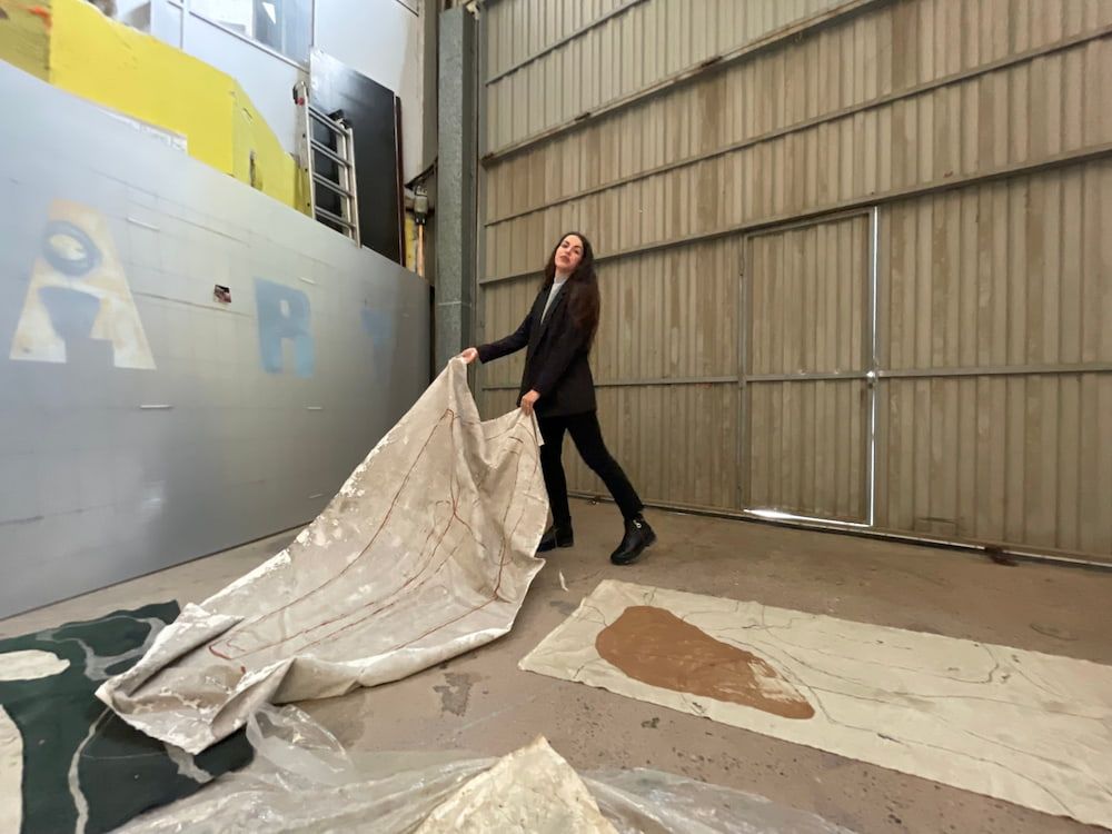 local artist moves canvas around in studio