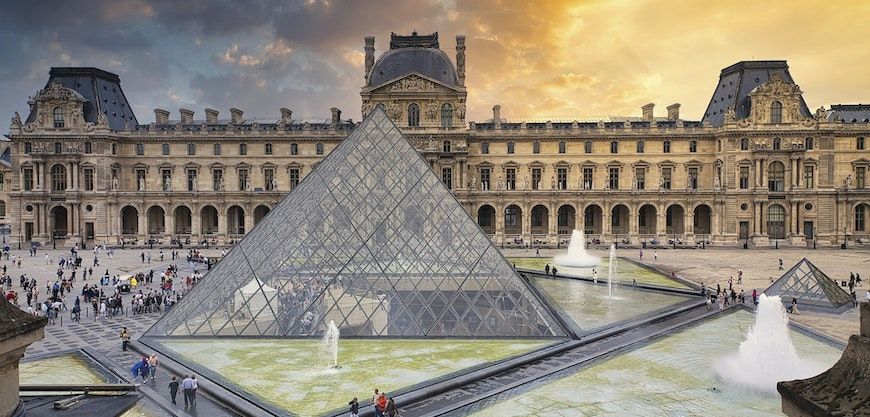 the louvre pyramid and buildings in background