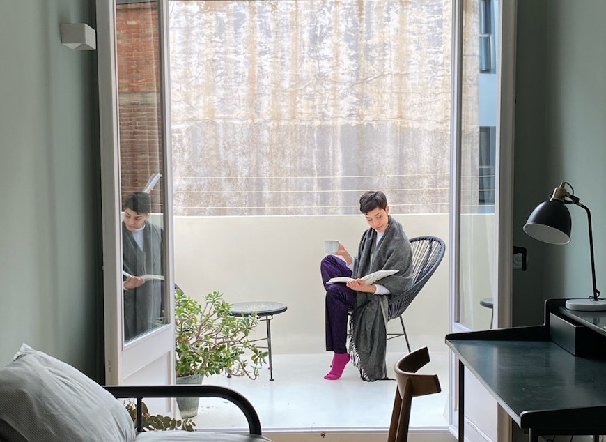 woman reading on balcony
