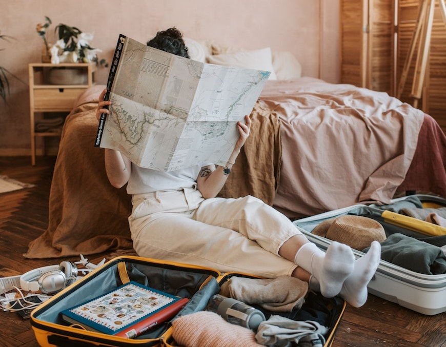 reading map on floor by suitcases