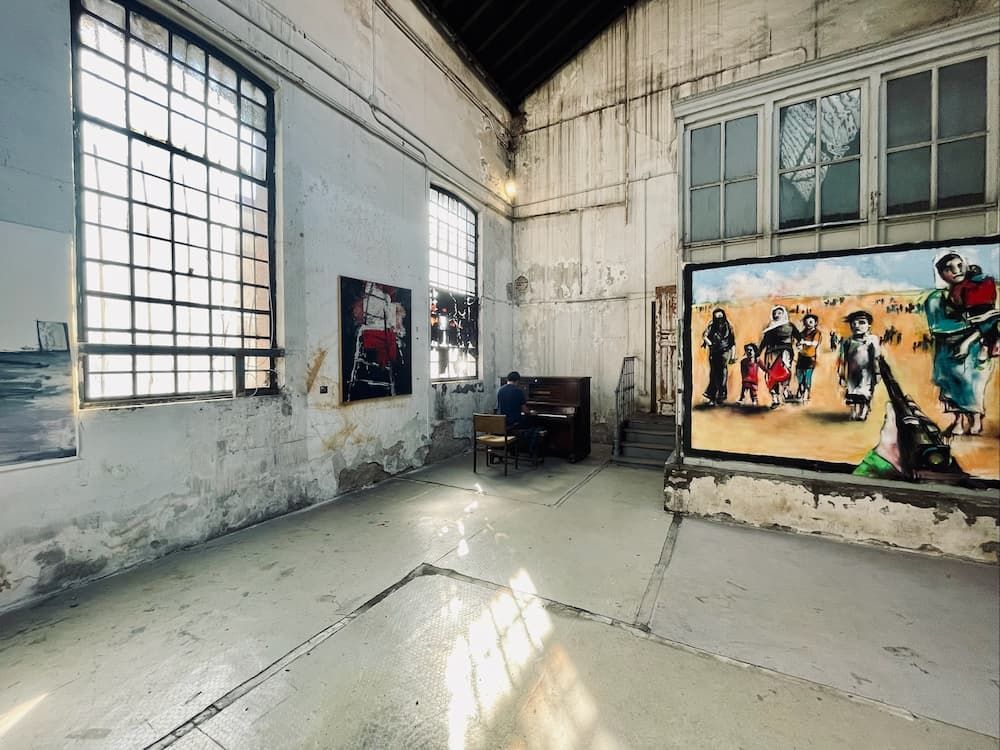 Gallery with white walls, piano, and artpiece