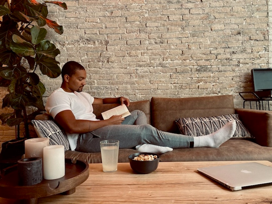 man reading on couch