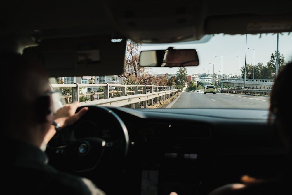 view from back seat of person driving car