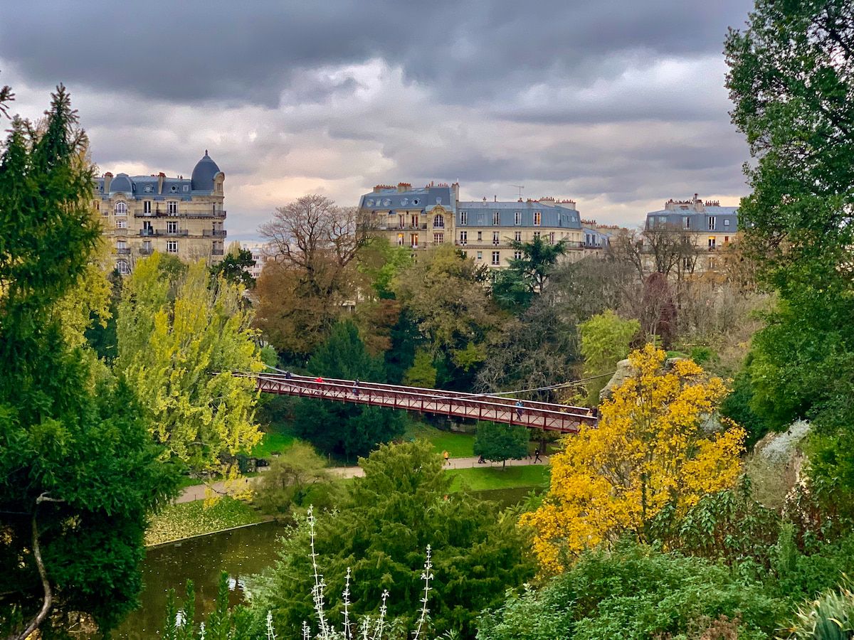 park greenery with trees and view of houses