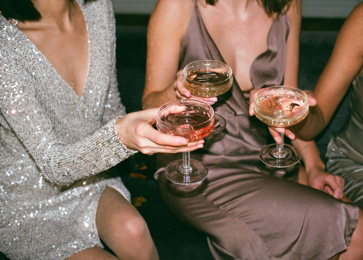 three people cheersins champagne