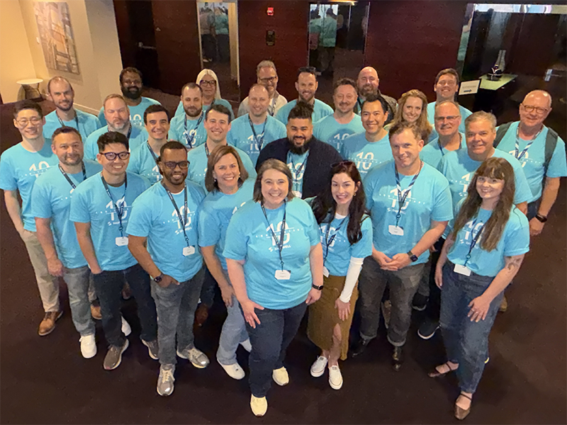 Shipwell employees in a group, wearing 10-year anniversary shirts.