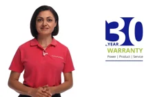Woman wearing a red polo shirt standing and smiling against a white background with a blue and green '30 Year Warranty' logo beside her.