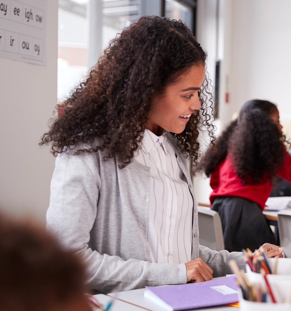 A teacher smiles at a student.