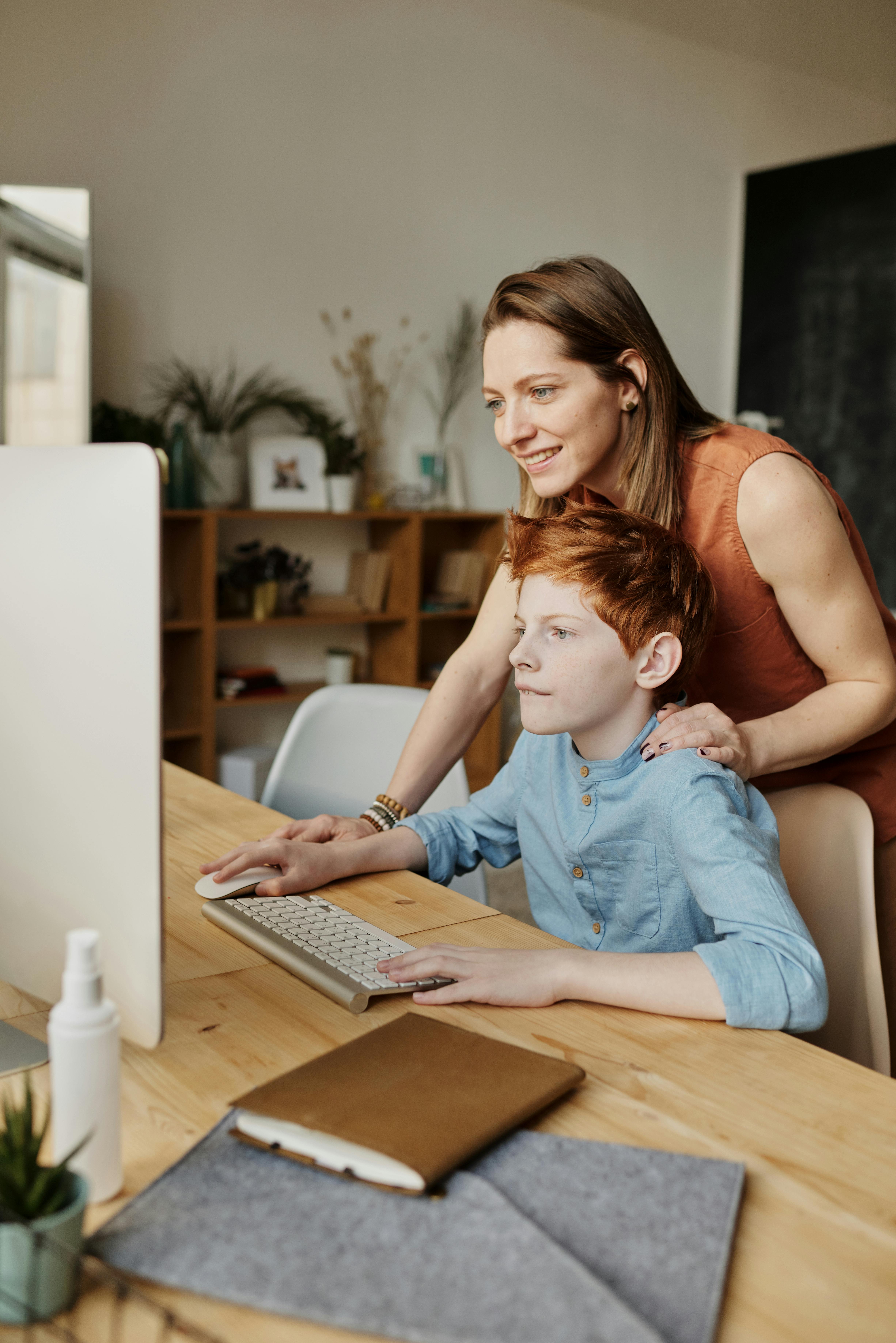Child at home focused on completing homework from the Kiddo Genius program.