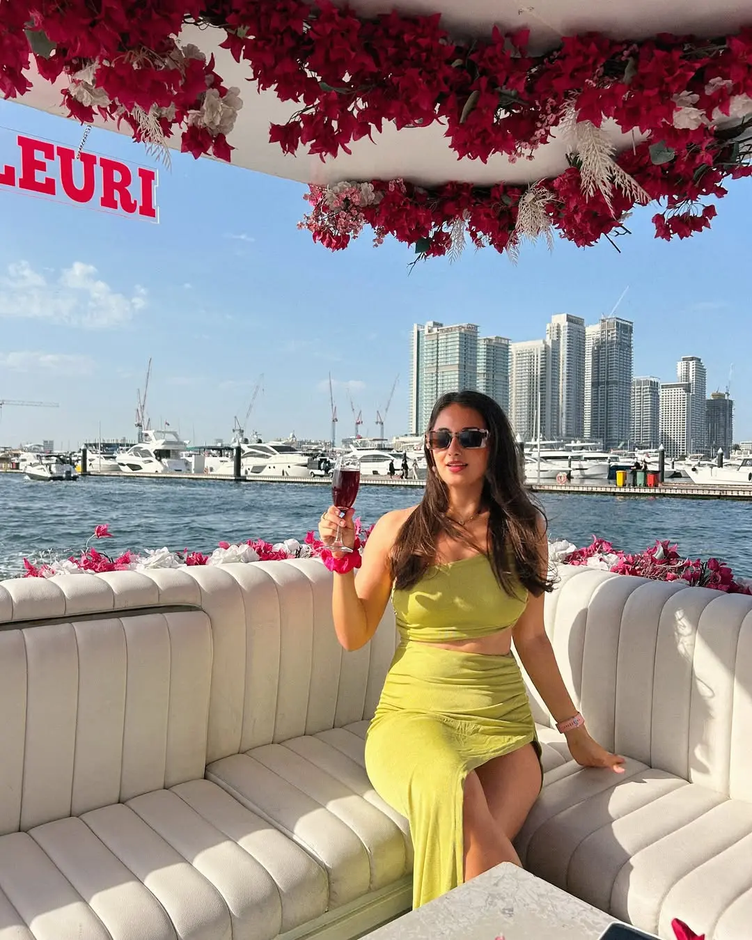 young lady drinking a glass of juice ready to go on cruise in Dubai Marina