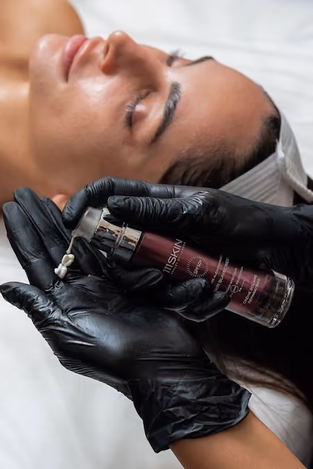 Applying SPF 50+ after facial treatment