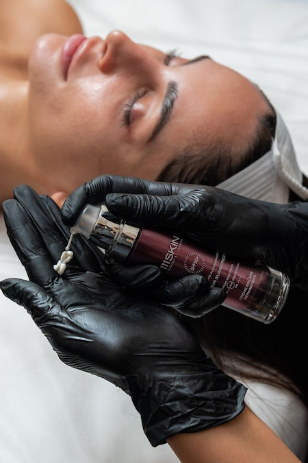 Applying SPF 50+ after facial treatment