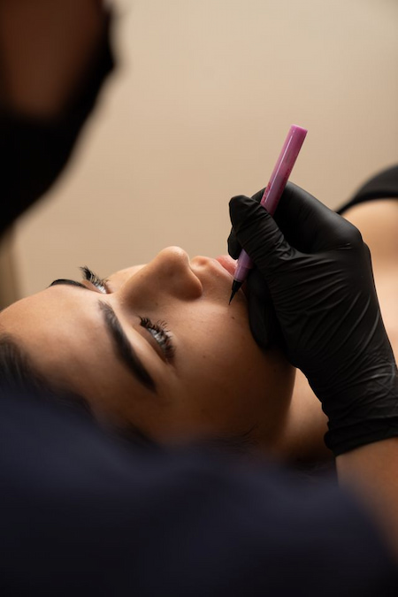 Artist mapping beauty spot placement with a pencil before application