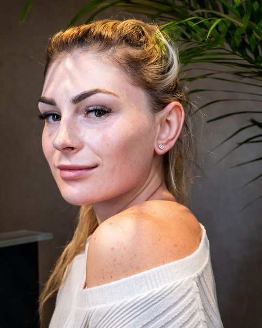 Client with soft, natural-looking lash extensions and defined brows