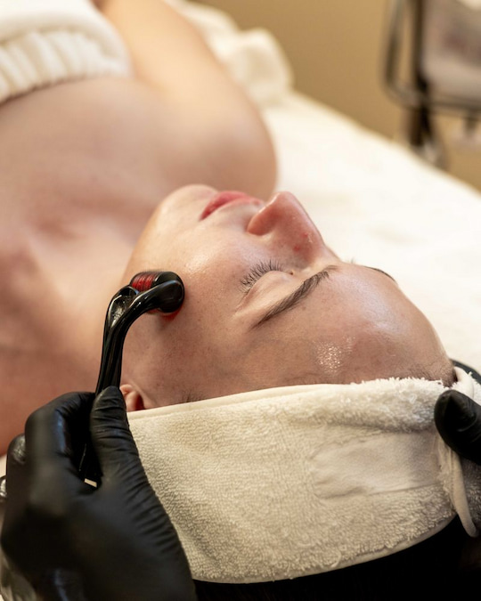 Facial treatment being performed on a client's cheek