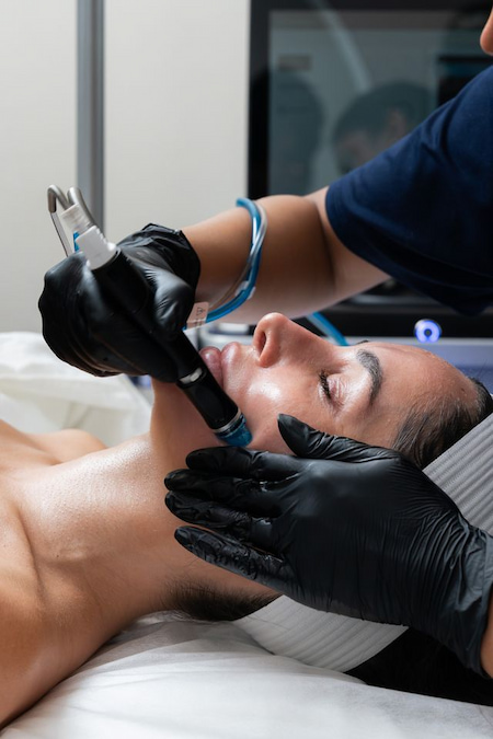 HydraFacial device being used on a client during treatment