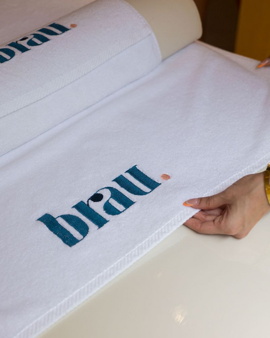Brau branded towel being prepared in the treatment room